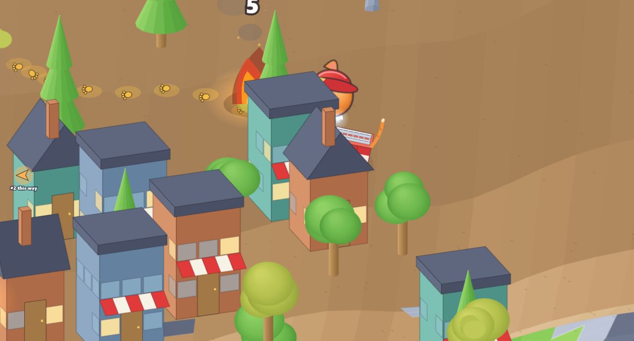 Power Kittens gameplay: an orange kitten in a fire truck sprays an arc of blue water toward a fire beside a building in a colorful low-poly town